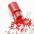 Vibrant red 2mm glass seed beads in a clear bottle for DIY jewelry making - Red