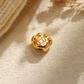 Macro detail of a golden 304 stainless steel cat paw bead with white and pink enamel inlay - Pink (TP1005-02-pink)