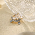 Close-up of blue and white enamel flower pendant with gold plated stainless steel edges - Grey Blue (TP1048-02-blue)