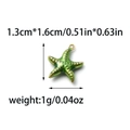 Detailed view of a green starfish charm in 304 stainless steel with golden dotted relief - Starfish Shape (TP1396-02-green)
