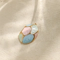 Macro shot of oval gold stainless steel pendant with colorful marble enamel details - Light Color Geometric Splicing Style (TP1083-02-qianse)