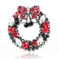 Detailed view of silver Christmas wreath brooch with red and green rhinestones and a bow - Antique Silver Colorful