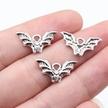 Antique silver bat charms for DIY jewelry making shown in hand for scale and detail - Antique Silver