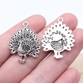 Antique silver peacock pendants showing front and back details for jewelry making - Antique Silver