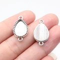 Silver teardrop geometric gemstone base connector for DIY jewelry making displayed on a finger - Teardrop (B18136)