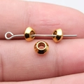 Polished bright gold 6mm spacer beads for DIY jewelry making shown on silver pin - Antique Gold