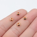 Golden 6mm abacus beads made of metal for DIY jewelry making shown on a fingertip - KC Gold