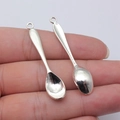 Silver vintage spoon charm pendant for DIY jewelry making held in hand for size - Antique Silver