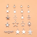Set mit 19 verschiedenen antiken Silber-Sternanhängern für DIY-Schmuck auf Pfirsichgrund - Antiksilber