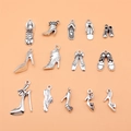 Set of 13 vintage silver alloy shoe charms including high heels and sneakers - Antique Silver