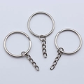Flat lay of three silver metal key rings with short chain connectors for DIY jewelry - Nickel