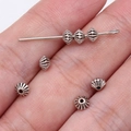 Silver carved conical spacer beads for jewelry making held in hand for scale - Antique Silver (B17102_W22-E06)