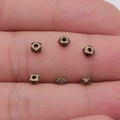 DIY jewelry beads in geometric faceted design with bronze finish on fingertips - Antique Bronze