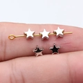 Tiny 5.6mm silver star-shaped beads for DIY jewelry making shown on finger for scale - White Gold