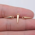 Three tiny golden cone pendants for DIY jewelry shown on a fingertip for size - KC Gold