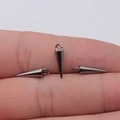 Three gunmetal cone pendants with hanging loops displayed on a finger for size reference - Gunmetal