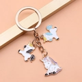 Golden alloy unicorn keychain charm with white enamel droplets and three pendants - Unicorn Style (XY30090)