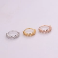 Macro detail of three-color minimalist piercing rings with wavy pavé zircon settings - Silver / Style 3