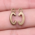 Set of two vintage bronze letter C pendants for DIY jewelry making on a finger for scale - Capital Letter C (A13210)