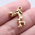 Golden female volleyball player sports charm pendant with embossed athletic details - Antique Gold