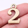 Antique bronze number 2 metal pendant for DIY jewelry making shown on fingertips - Antique Bronze Number 2 (A13359)