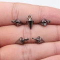Set of five gunmetal bullet cone charms for DIY jewelry making displayed on hand - Gunmetal