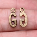 Antique bronze metal letter G charm for DIY jewelry making held in hand to show size - Capital Letter G (A13214)