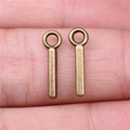 Antique bronze metal alphabet letter charms with long strip shape shown on fingertips - Capital Letter I (A13216)