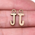 Antique bronze letter J charms for DIY jewelry making shown on finger for scale - Capital Letter J (A13217)