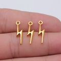 Three mini gold lightning bolt alloy pendants for DIY jewelry making shown on hand - Bright Gold