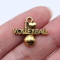 Golden I Love Volleyball pendant with 3D volleyball charm held between fingers - Antique Gold