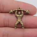 Bronze weightlifter charm for DIY jewelry making shown held between fingers - Weightlifting Athlete (ABD-C14906) / Antique Bronze