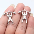Silver weightlifter charm for DIY jewelry making shown on fingertips for scale - Weightlifting Athlete (ABD-C14906) / White Gold