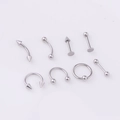 Macro display of 8 stainless steel body piercing studs including eyebrow and lip rings - 8 Pieces/Set / Steel