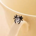 Black spider ear stud with heart-shaped zircon on a beige ceramic cup handle - Single Piece / White (Single Piece)