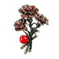Detailed macro view of vintage flower brooch with red rhinestones and a large pearl bead - Antique KC Gold