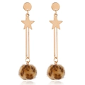 Detail of star pendant and leopard print fur ball on long gold earrings with white background - Coffee Leopard