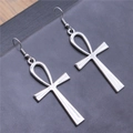 Vintage silver Ankh cross drop earrings with fishhook wires on a textured dark background - Antique Silver