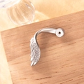 Silver curved belly button ring featuring a zircon-encrusted wing pendant on a wooden base - Right Side Style (A338) / 0.8mm Thread