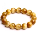 Macro detail of natural tiger eye stone beads with golden luster and cat eye effect - 6mm / Gold Tiger Eye