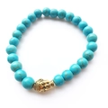 Bracelet tête de Bouddha bouddhiste avec perles de turquoise bleues et métal doré - Style Bouddha Or en Turquoise