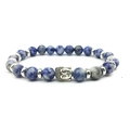 Blue volcanic stone beaded bracelet with silver Buddha head charm on white background - Blue Spot Stone