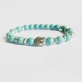 Blue turquoise bead bracelet featuring a silver Buddha head and decorative metal spacers - Blue Turquoise