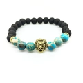 Lava stone and blue emperor stone bead bracelet with a golden lion head charm detail - Light Blue Beads And Gold Lion Head