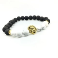 Detail of beaded bracelet with black lava stone, white marble beads and golden lion head - White Beads And Gold Lion Head