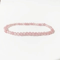 Macro view of 4mm rose quartz beads on a polished pink crystal energy stretch bracelet - Rose Quartz