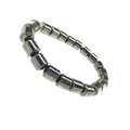 Macro shot of dark grey magnetic hematite beads on a minimalist elastic bracelet - Cylinder Beads (No. 2)