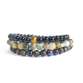 Close-up of stacked natural stone bracelets with tiger eye, onyx, and lapis beads - Bracelet Set