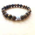 Macro shot of tiger eye beaded bracelet with a white marble focal stone - Yellow Tiger Eye Style