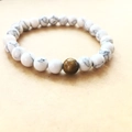 Detailed view of white turquoise beads with a brown tiger eye stone on elastic cord - White Turquoise Style